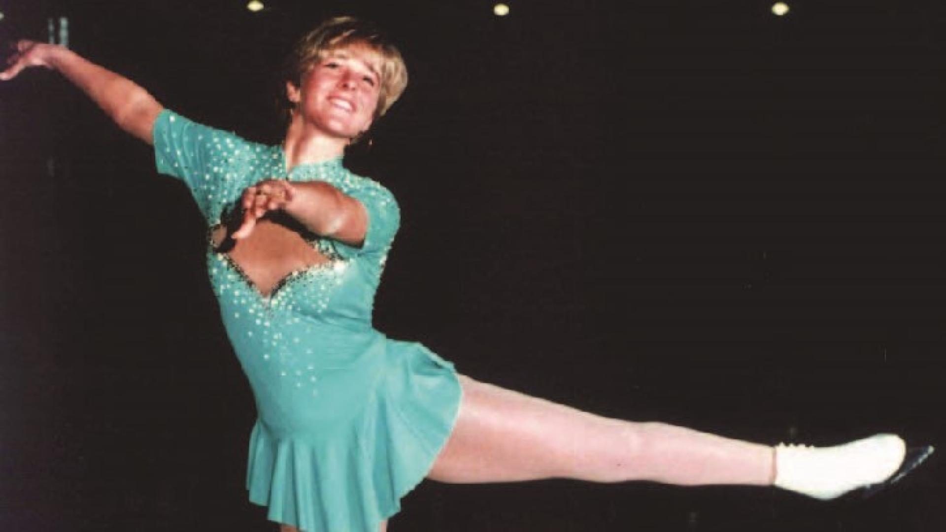 Shannon Allison Collins strikes a figure skating pose on the ice.